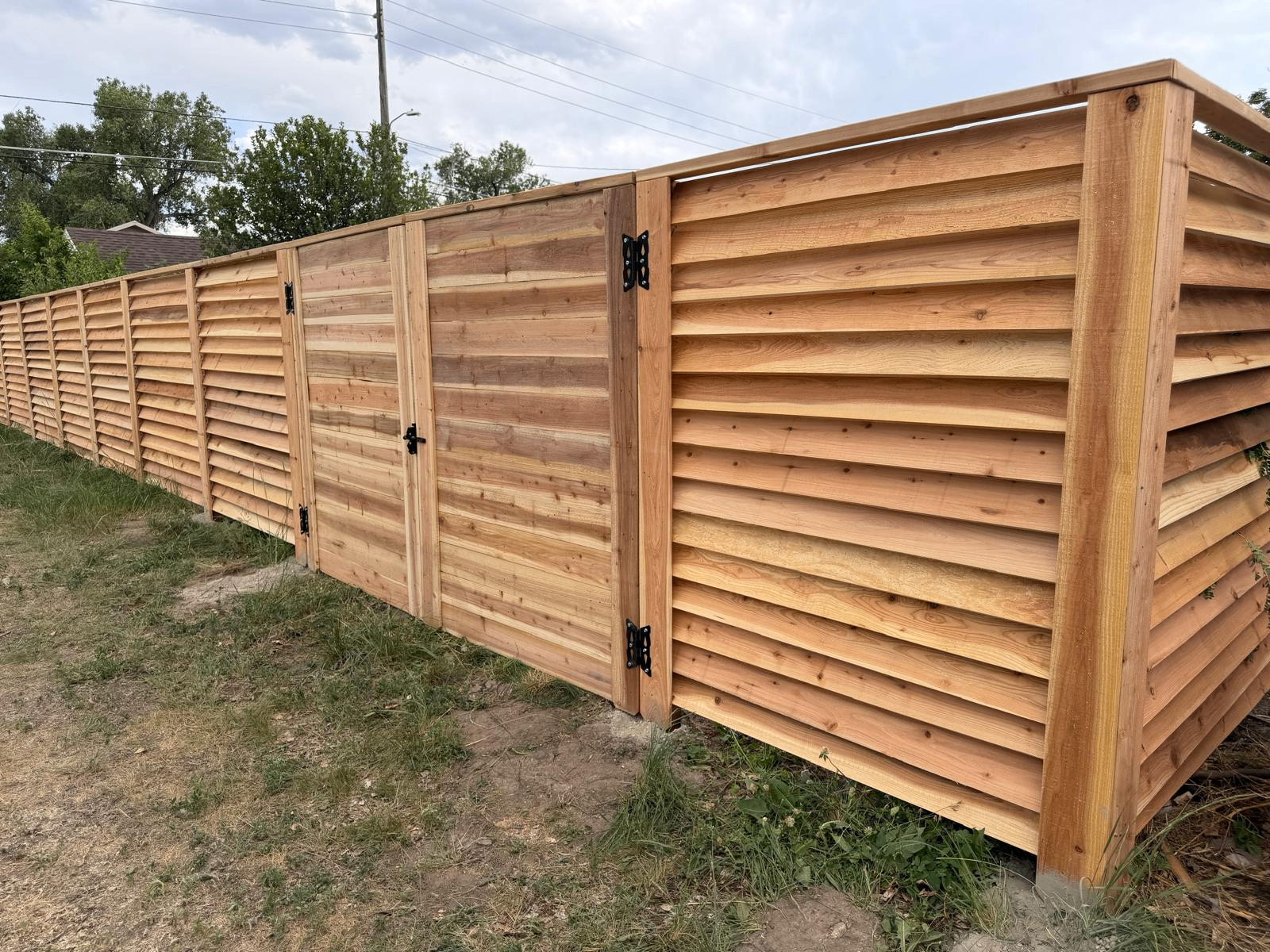 Modern horizontal cedar fence and gate installation showcasing craftsmanship