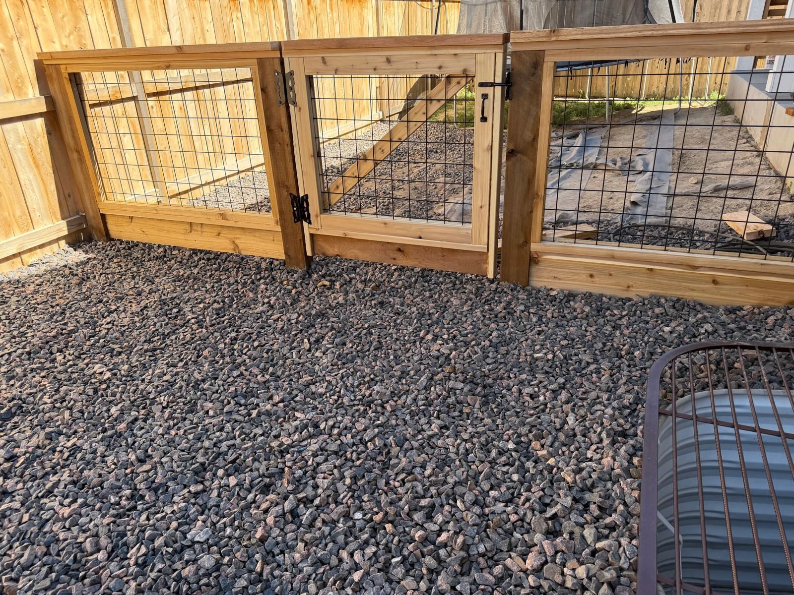Custom dog run fence with wire panel framing and cedar construction